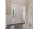 Inviting entryway features stylish flooring, fresh paint, and natural light from sidelight windows at 5712 Grande River Rd, Atlanta, GA 30349