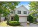Charming two-story home features a well-manicured lawn, attached garage, and classic architectural details at 5712 Grande River Rd, Atlanta, GA 30349