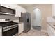Modern kitchen features granite countertops, stainless steel appliances, white cabinets, and tiled backsplash at 5712 Grande River Rd, Atlanta, GA 30349