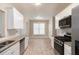 Modern kitchen features granite countertops, stainless steel appliances, white cabinets, and tiled backsplash at 5712 Grande River Rd, Atlanta, GA 30349