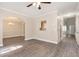 Open-concept living room with hardwood floors and archway to the dining area at 5712 Grande River Rd, Atlanta, GA 30349