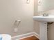 Simple half bathroom with pedestal sink and wood flooring at 5712 Grande River Rd, Atlanta, GA 30349