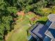 Aerial view showcases a deck and manicured backyard with winding stone paths, lush greenery, and established trees at 710 Bentgrass Ct, Dacula, GA 30019