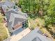 Aerial view of the property highlighting the screened porch, backyard, driveway and a basketball hoop at 710 Bentgrass Ct, Dacula, GA 30019