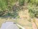 The aerial view displays the property's backyard, complete with a charming stream, walking paths, and a fire pit at 710 Bentgrass Ct, Dacula, GA 30019
