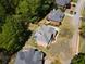 An aerial view showcases a beautiful home with mature trees, manicured lawns and an outdoor space designed for relaxation at 710 Bentgrass Ct, Dacula, GA 30019