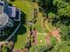 An aerial view captures a manicured backyard, highlighted by meandering stone paths and lush green lawns at 710 Bentgrass Ct, Dacula, GA 30019