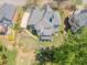The aerial shot showcases a well-manicured yard with walking paths, a stream, and a fire pit at 710 Bentgrass Ct, Dacula, GA 30019