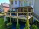 View of the back of the home featuring a spacious deck with an awning and walkout basement at 710 Bentgrass Ct, Dacula, GA 30019