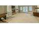 Finished basement living area featuring built-in bookshelves, fireplace, and French doors at 710 Bentgrass Ct, Dacula, GA 30019