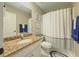 Bathroom with a granite countertop, white cabinets, and a shower with blue accents at 710 Bentgrass Ct, Dacula, GA 30019