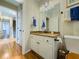 Bathroom features a granite countertop, white cabinets, mirror, and blue towels at 710 Bentgrass Ct, Dacula, GA 30019