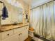 Bathroom vanity with granite countertop and shower with curtain in neutral tones at 710 Bentgrass Ct, Dacula, GA 30019