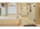 The bathroom features a soaking tub next to a glass enclosed shower with seat and rainfall shower head at 710 Bentgrass Ct, Dacula, GA 30019