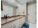 Bathroom featuring granite countertop, double sinks, and white cabinets for a clean look at 710 Bentgrass Ct, Dacula, GA 30019