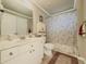 Bathroom with shower-tub, neutral paint, large vanity, and decorative rug at 710 Bentgrass Ct, Dacula, GA 30019