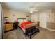 Nicely furnished bedroom featuring a ceiling fan, neutral walls, and a dark wood bed frame at 710 Bentgrass Ct, Dacula, GA 30019