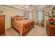 This bedroom features an ornate bed frame, tray ceiling, and decoratively curtained windows at 710 Bentgrass Ct, Dacula, GA 30019