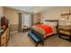 Cozy bedroom with a ceiling fan, neutral walls, and a window for natural light at 710 Bentgrass Ct, Dacula, GA 30019