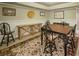Finished basement area with a dining table and furniture, with neutral decor and tile floors at 710 Bentgrass Ct, Dacula, GA 30019