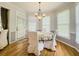 Cozy dining area bathed in natural light from large windows with hardwood floors at 710 Bentgrass Ct, Dacula, GA 30019