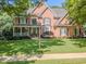 Beautiful two-story brick home with manicured lawn and inviting front porch at 710 Bentgrass Ct, Dacula, GA 30019