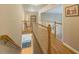 Upstairs hallway featuring hardwood floors and railings overlooking the staircase and entry at 710 Bentgrass Ct, Dacula, GA 30019