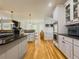 Modern kitchen with hardwood floors, granite countertops, and stainless steel appliances at 710 Bentgrass Ct, Dacula, GA 30019