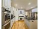 Spacious kitchen boasts white cabinets, stainless appliances, and a large central island at 710 Bentgrass Ct, Dacula, GA 30019