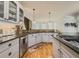 Open kitchen with stone countertops, stainless steel appliances, and hardwood floors at 710 Bentgrass Ct, Dacula, GA 30019