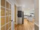 Entry way view of the kitchen featuring an island and stainless steel refrigerator at 710 Bentgrass Ct, Dacula, GA 30019