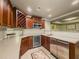 Finished basement kitchenette featuring dark wood cabinets, wine cooler and stainless steel appliances at 710 Bentgrass Ct, Dacula, GA 30019
