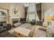Bright living room with fireplace, tall ceilings, and large windows at 710 Bentgrass Ct, Dacula, GA 30019