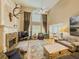 Spacious living room with a stone fireplace, tall windows, and hardwood floors at 710 Bentgrass Ct, Dacula, GA 30019