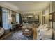 Comfortable living room with custom bookshelves, a cozy couch, and ample natural light at 710 Bentgrass Ct, Dacula, GA 30019
