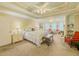 Bright main bedroom with decorative tray ceilings, sitting area, and large windows at 710 Bentgrass Ct, Dacula, GA 30019