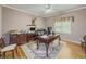 Office space featuring hardwood floors, ceiling fan, large desk, and decorative details at 710 Bentgrass Ct, Dacula, GA 30019