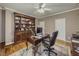Office space with ceiling fan, built-in shelves, hardwood floors, and neutral colored walls at 710 Bentgrass Ct, Dacula, GA 30019