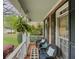 Cozy front porch with wicker chairs, a small table, and a view of the neighborhood at 710 Bentgrass Ct, Dacula, GA 30019