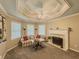 Cozy sitting area featuring a fireplace, window views, and decorative ceilings at 710 Bentgrass Ct, Dacula, GA 30019