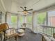 Relaxing sunroom with wicker furniture and large windows overlooking the yard at 710 Bentgrass Ct, Dacula, GA 30019