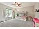 Bedroom featuring a bunk bed with carpeting, ceiling fan, and a sunlit window at 108 Shawville Ln, Peachtree City, GA 30269