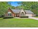 Charming single-story home with a brick facade, well-manicured lawn, and mature trees at 108 Shawville Ln, Peachtree City, GA 30269