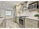 Spacious kitchen featuring granite counters, stainless steel appliances, custom cabinets, and updated backsplash at 108 Shawville Ln, Peachtree City, GA 30269