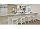 Well-lit kitchen with stainless steel appliances, granite countertops, an island with bar seating, and a sliding barn door at 108 Shawville Ln, Peachtree City, GA 30269