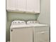 Laundry area with a side by side washer and dryer and cabinets at 108 Shawville Ln, Peachtree City, GA 30269