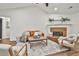 Bright living room featuring a brick fireplace and comfortable seating at 108 Shawville Ln, Peachtree City, GA 30269