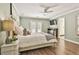 Serene main bedroom features hardwood floors, a ceiling fan, access to a private balcony, and neutral walls at 108 Shawville Ln, Peachtree City, GA 30269