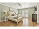 Relaxing main bedroom showcasing hardwood floors, a ceiling fan, french doors to a balcony, and neutral decor at 108 Shawville Ln, Peachtree City, GA 30269