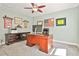 Bright home office featuring carpeting, a ceiling fan, desk, and decor at 108 Shawville Ln, Peachtree City, GA 30269